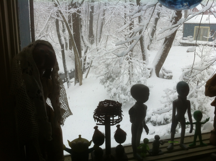 Some dolls on my windowsill, looking out at the snow.